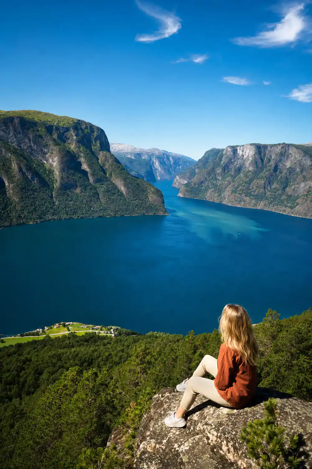 A deep blue fjord narrowing between two vertical walls