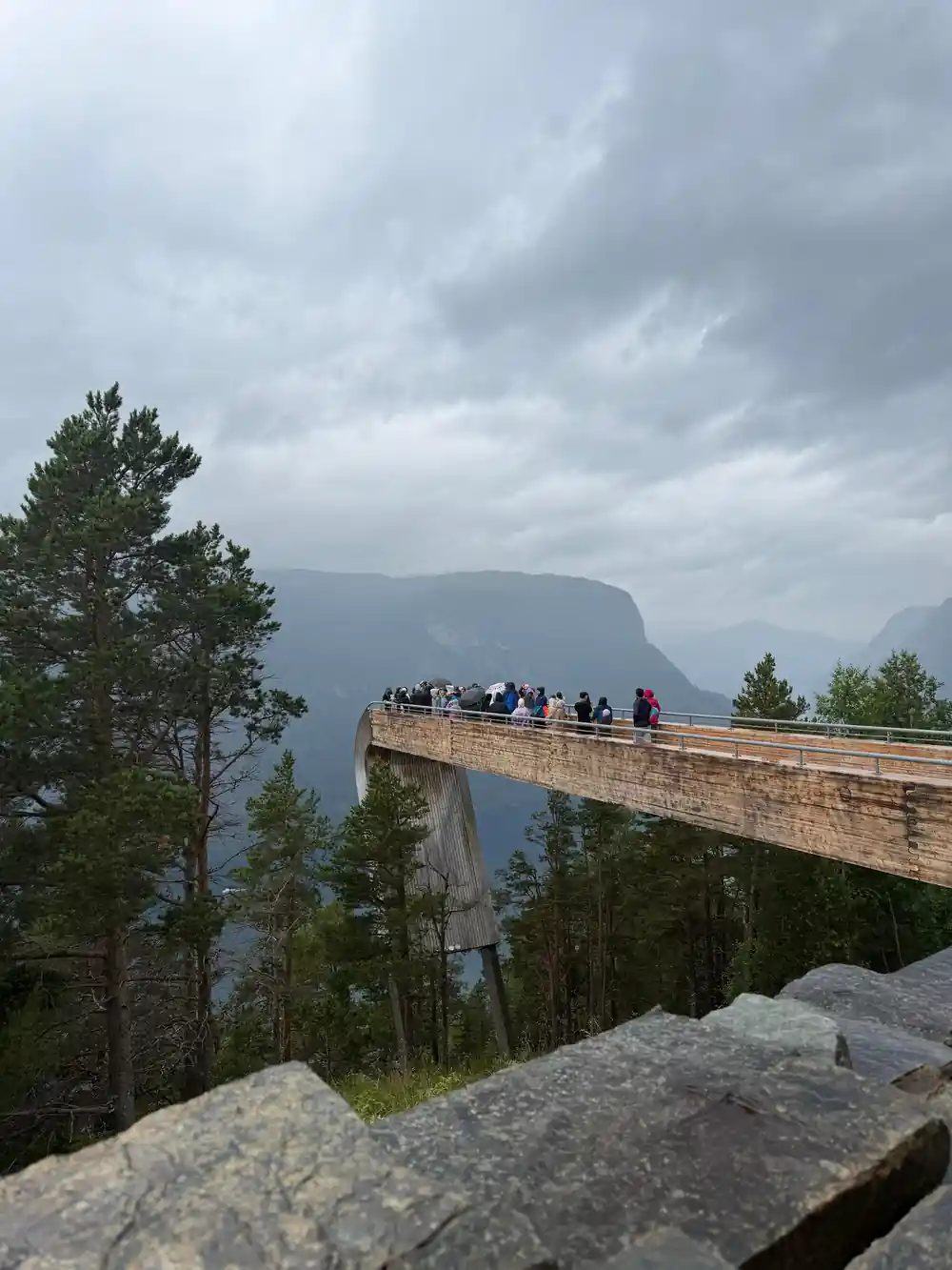 The platform seen end on with visitors along it above cloud