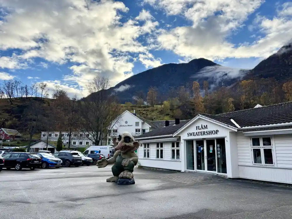 A troll figure outside a timber shop building at Flam