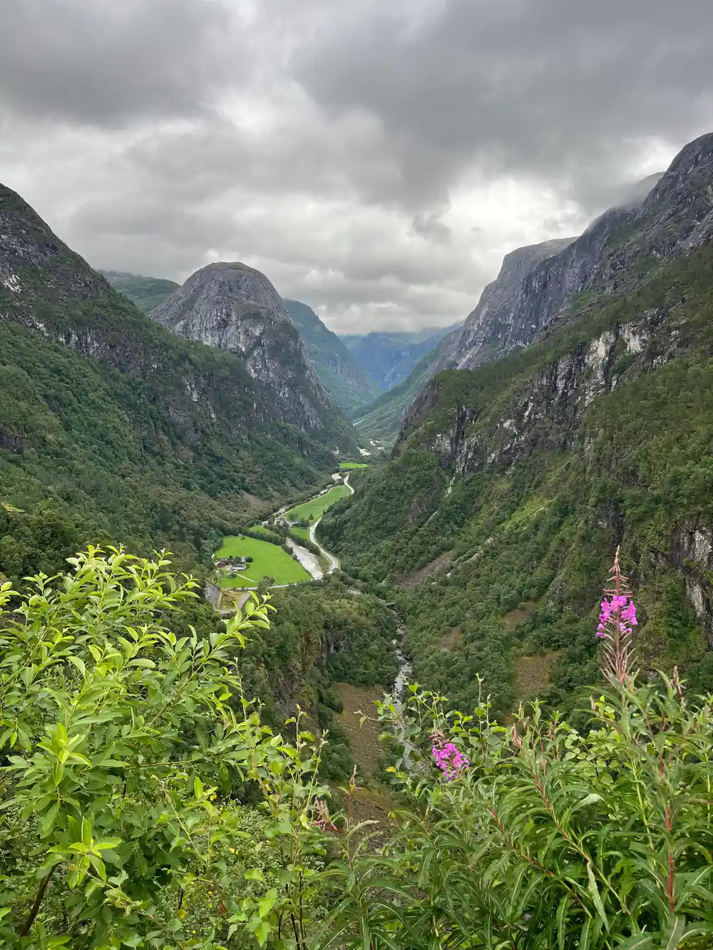 The valley road far below between two mountain walls